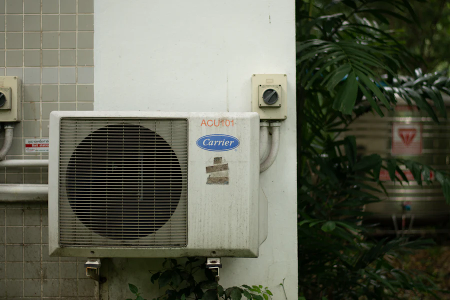 Old, worn outdoor AC condenser unit before replacement